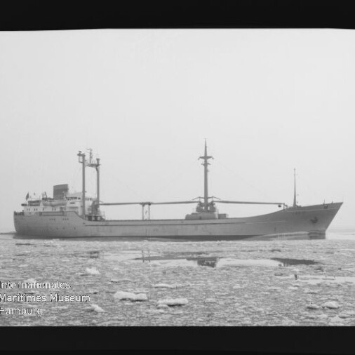 Frachtschiff in Seitenansicht auf eisbedeckter See, schwarzweiß Fotografie mit Museumswasserzeichen unten links.