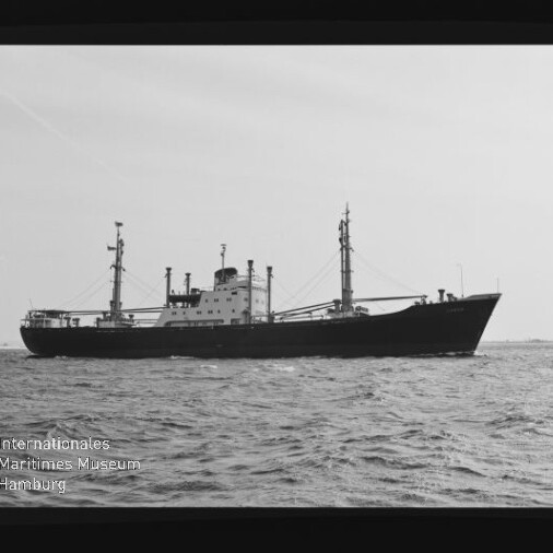 Schwarzweiß-Seitenansicht eines Frachtschiffs mit Masten auf ruhiger See; unten links Text Internationales Maritimes Museum.