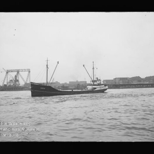 Schiff vor Industriehafen mit Kransilhouette und Brücke im Hintergrund; Wasserzeichen 
