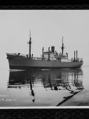 Frachtschiff mit Schornstein und Masten auf ruhigem Wasser mit klarer Spiegelung, Text Maritimes Museum Hamburg sichtbar.