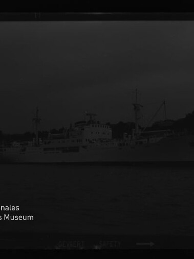 Schiff als helle Silhouette am Ufer bei dunklem Himmel; unten links Logo und Schriftzug des Maritimen Museums Hamburg.