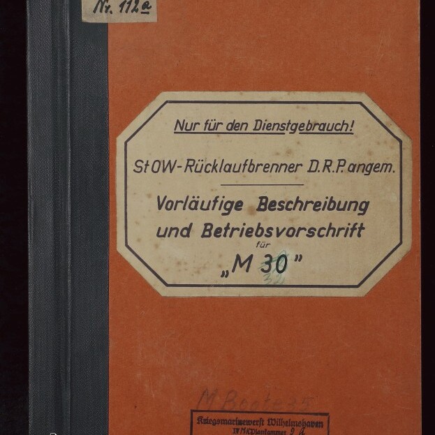 Orangener Einband eines technischen Handbuchs mit schwarzem Rücken; großes achteckiges Etikett mittig mit dem gedruckten Hinweis „Nur für den Dienstgebrauch!“ und dem Titel „Vorläufige Beschreibung und Betriebsvorschrift für ‚M 30‘“, oben links ein handschriftlicher Zettel sowie unten ein Stempel der Kriegsmarinewerft Wilhelmshaven und das Logo des Internationalen Maritimen Museums Hamburg.