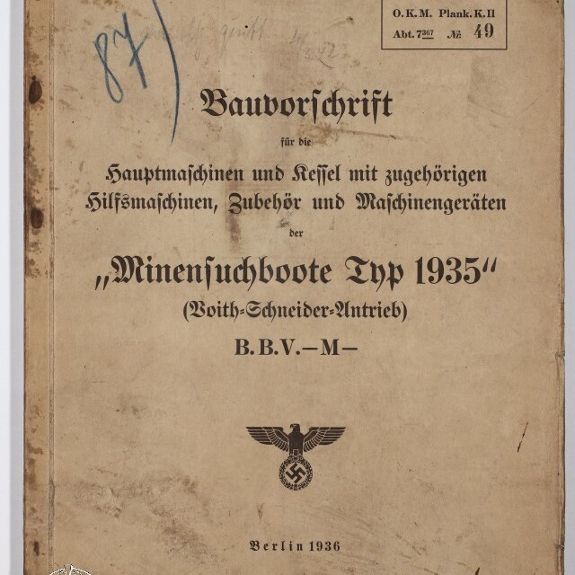 Vergilbtes Deckblatt eines technischen Diensthefts von 1936 mit dem Titel ‚Bauvorschrift … Minensuchboote Typ 1935‘, handschriftlichen Notizen und Stempeln, gedrucktem Reichsadler mit Hakenkreuz und Wasserzeichen des Internationalen Maritimen Museums Hamburg.